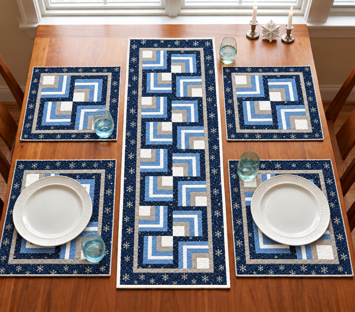Frosted Snowflake Log Cabin winter quilted table runner and four placemats in navy snowflake, ice blue, silver and white on a wooden dining table