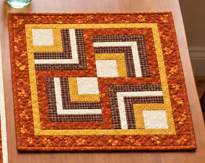 Fall Log Cabin quilted placemat with a spiral maze of pumpkin orange, cocoa brown, mustard and cream strips and a narrow inner border