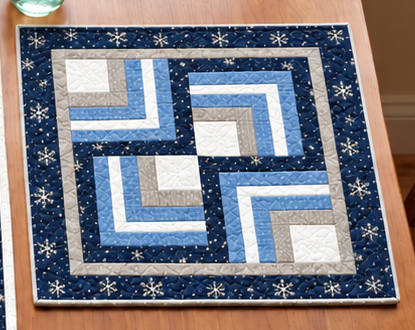 Winter Log Cabin quilted placemat with a spiral maze of ice blue, silver and white strips framed by navy snowflake print