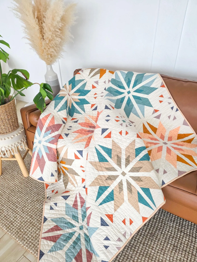 Sweet Creek Quilt Pattern PDF – geometric star throw quilt draped over leather sofa, boho home decor