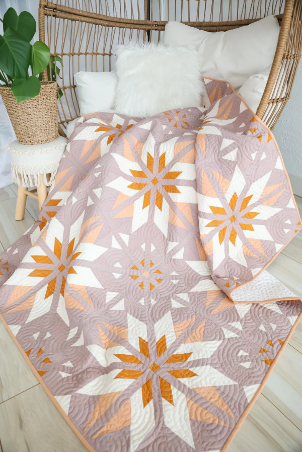 Sweet Creek Quilt Pattern PDF – blush pink star quilt draped over rattan chair, cottagecore home styling