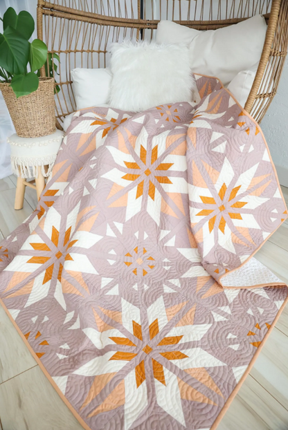 Sweet Creek Quilt Pattern PDF – blush pink star quilt draped over rattan chair, cottagecore home styling