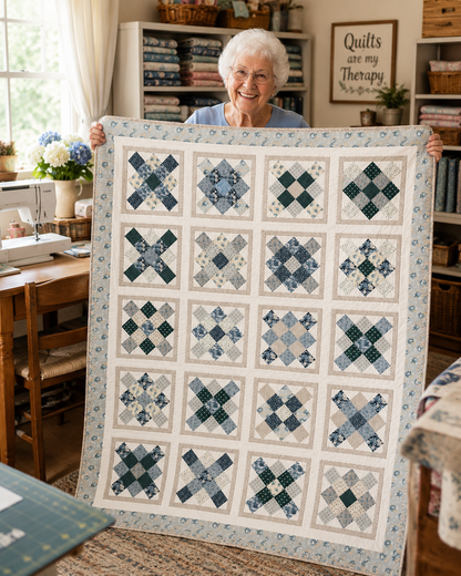 Happy quilter proudly holding a completed Sweet Serenity quilt pattern in a sewing room