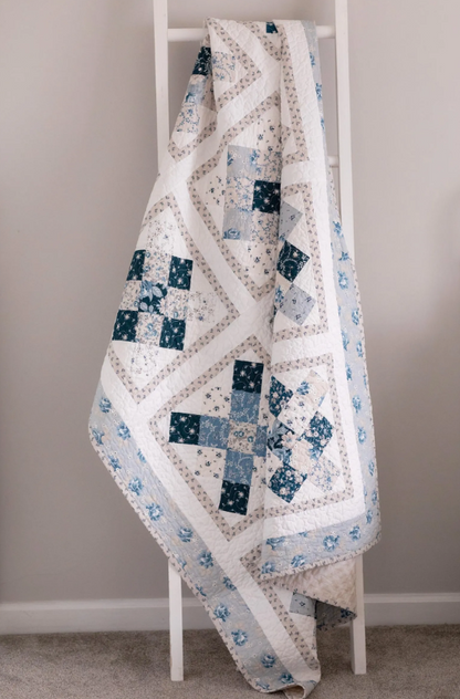 Sweet Serenity Quilt Pattern PDF - blue and white patchwork quilt draped over a ladder, beginner-friendly fat quarter design