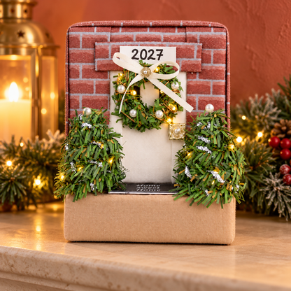 Finished folded fabric house ornament displayed on a Christmas mantel as a handmade holiday keepsake