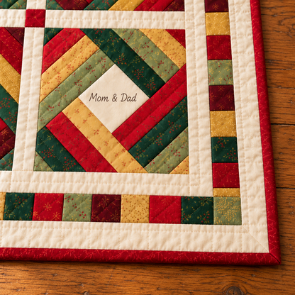 Corner of the Christmas Signature Quilt: signed cream window, pieced square border and red binding