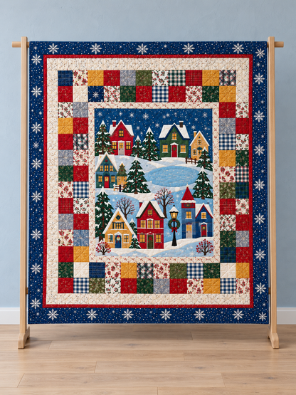 Full front view of a Christmas village panel quilt with navy snowflake and colorful patchwork borders. Illustrative fabric styling.