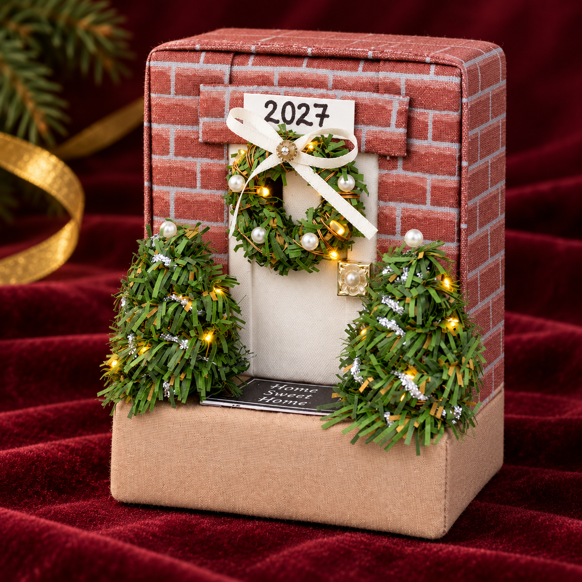 Right side view of the no-sew fabric cottage ornament on burgundy velvet, showing its dimensional house shape
