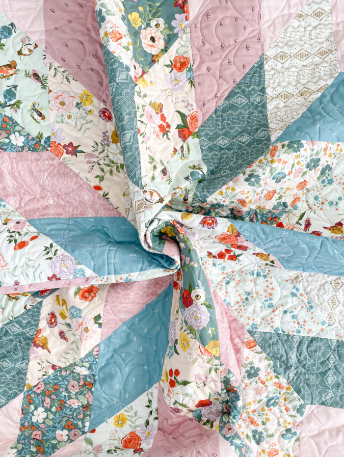Close-up of Floral Star quilt center showing pink, teal and floral fabric detail – modern patchwork star quilt PDF pattern