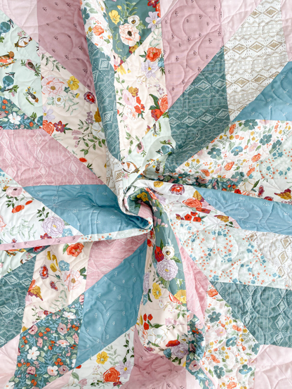 Close-up of Floral Star quilt center showing pink, teal and floral fabric detail – modern patchwork star quilt PDF pattern