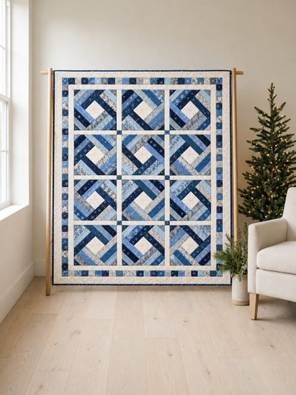 Frostlight Diamond blue and ivory quilt on an oak stand beside a Christmas tree