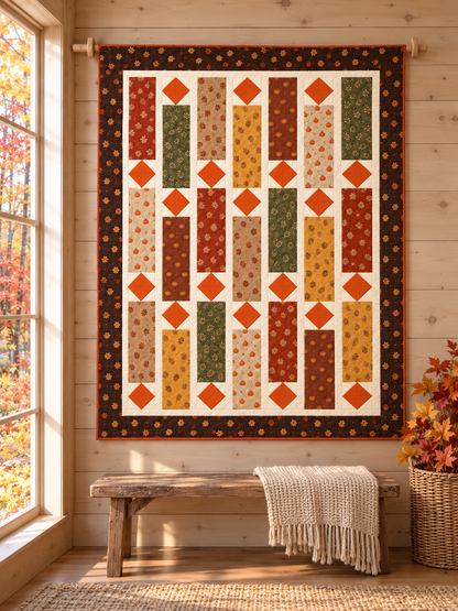 Fall quilt hanging on a wooden rod in a rustic cabin above a bench with a cream throw