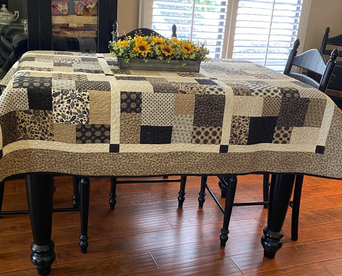 Layer Cake Toss Quilt as table runner – patchwork quilt pattern styled on dining table with sunflower decor