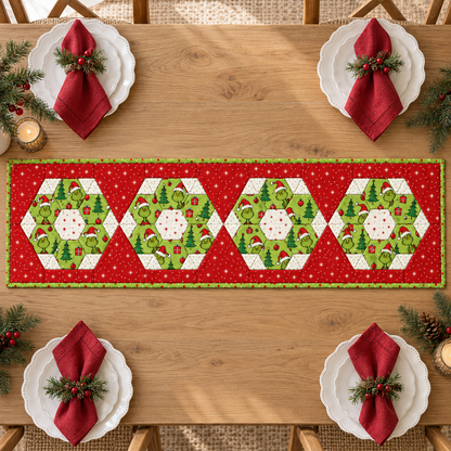 Overhead view of the red and green four-medallion Christmas table runner on an oak table