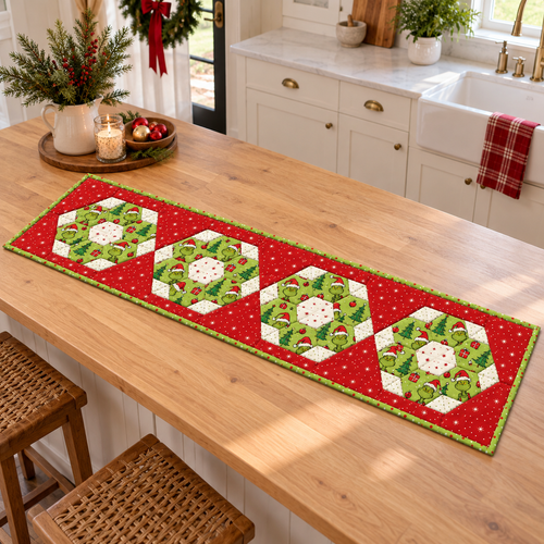 Christmas hexie table runner displayed on a light oak kitchen island