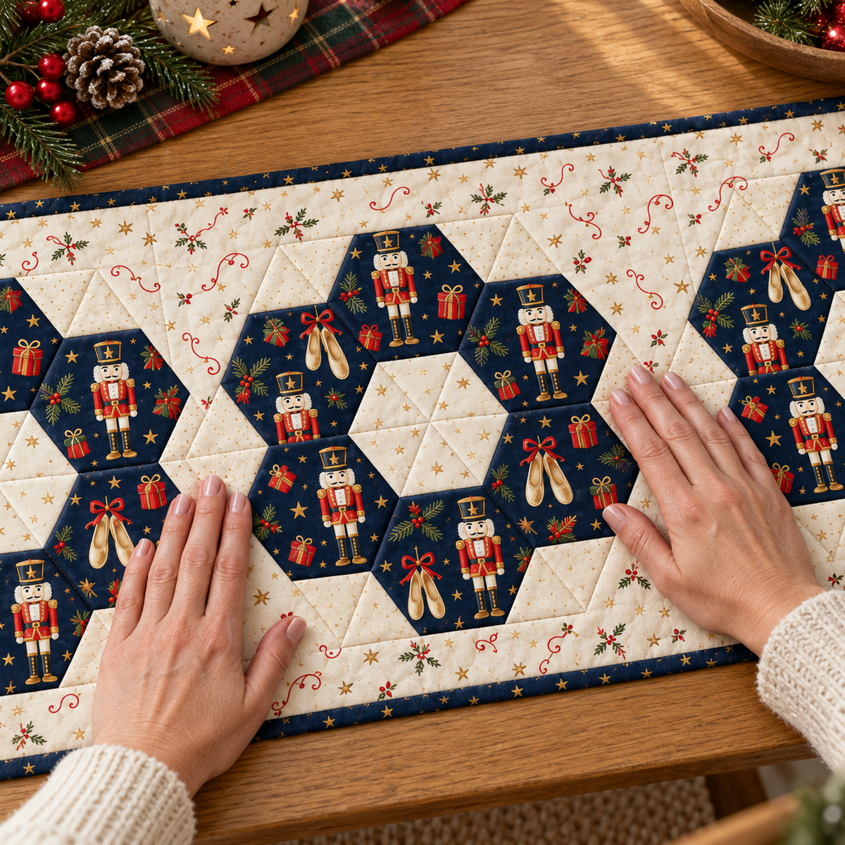 Hands smoothing a Nutcracker Noel medallion with six navy hexies and a pieced ivory center