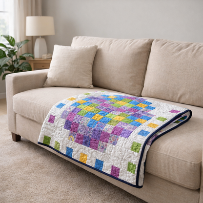 Pixel Easter egg quilt on living room sofa – colorful spring throw quilt PDF pattern, beginner-friendly patchwork design