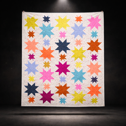 Starburst quilt hanging display on dark background showing full multicolour star pattern – modern patchwork quilt PDF instant download