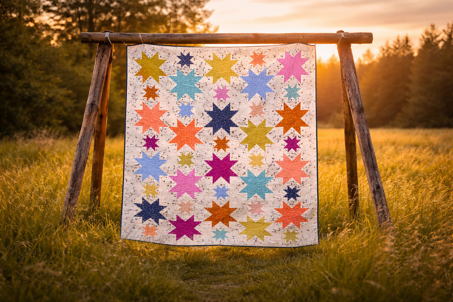 Starburst quilt on rustic wooden stand in sunset field – colourful multicolour star patchwork quilt PDF pattern beginner quilting